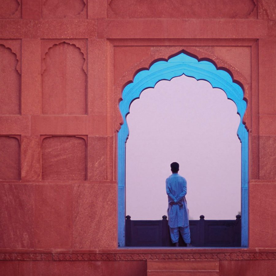Man standing between blue scenic cut-out window 