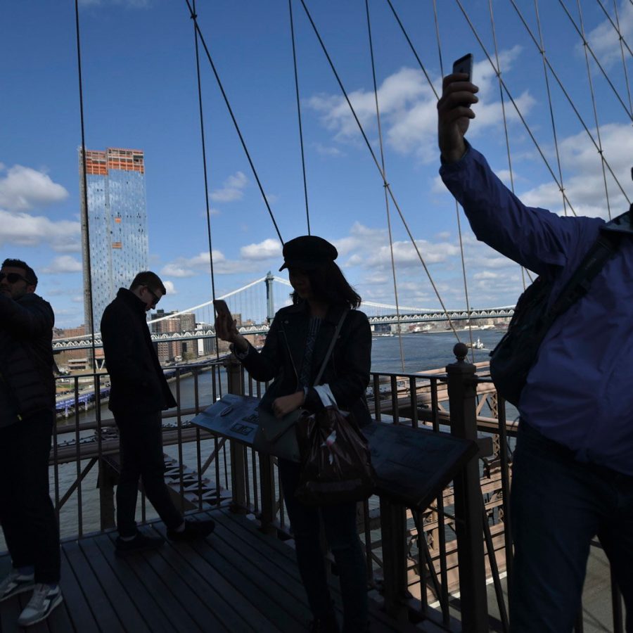 People taking selfies over a viewpoint 