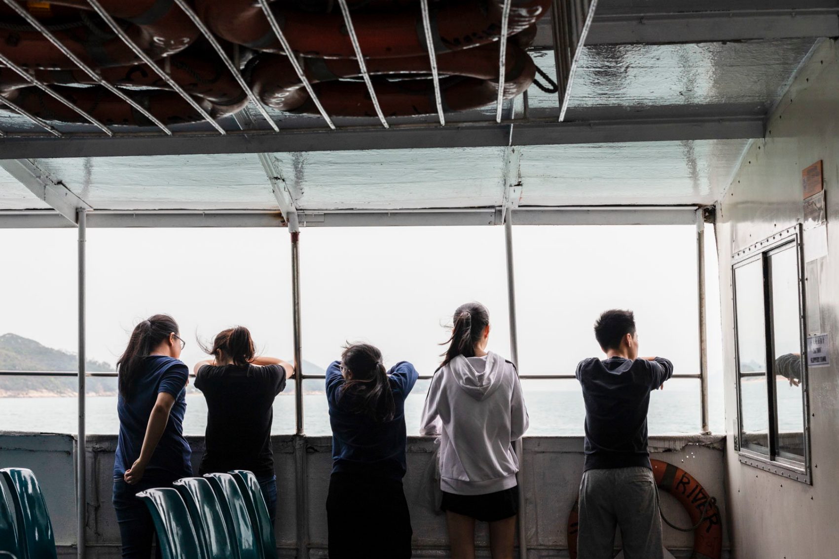 People looking at view on boat. Credit: Mike Pickes