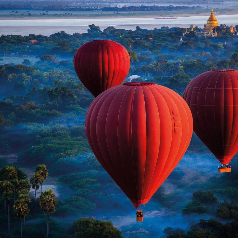 Three red hot air balloons in the sky