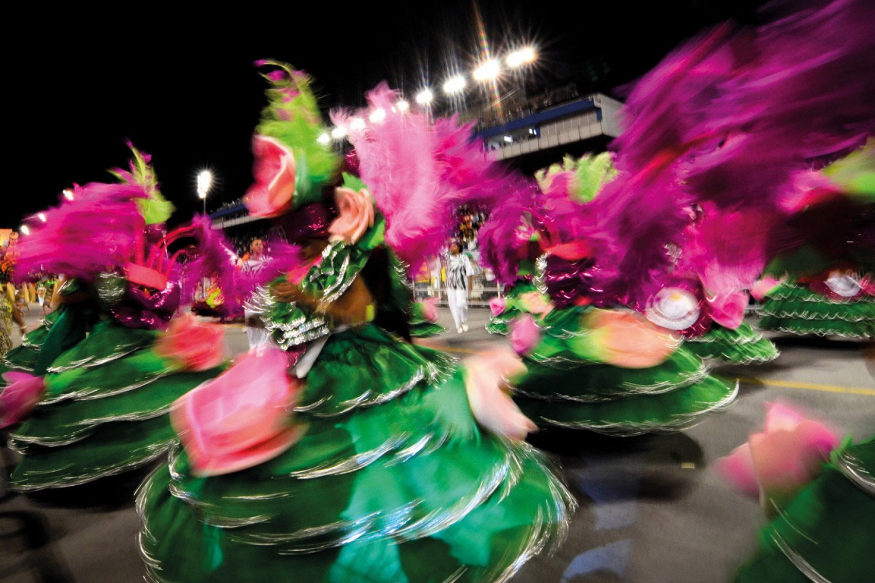 Dancers spinning in colourful green dresses 