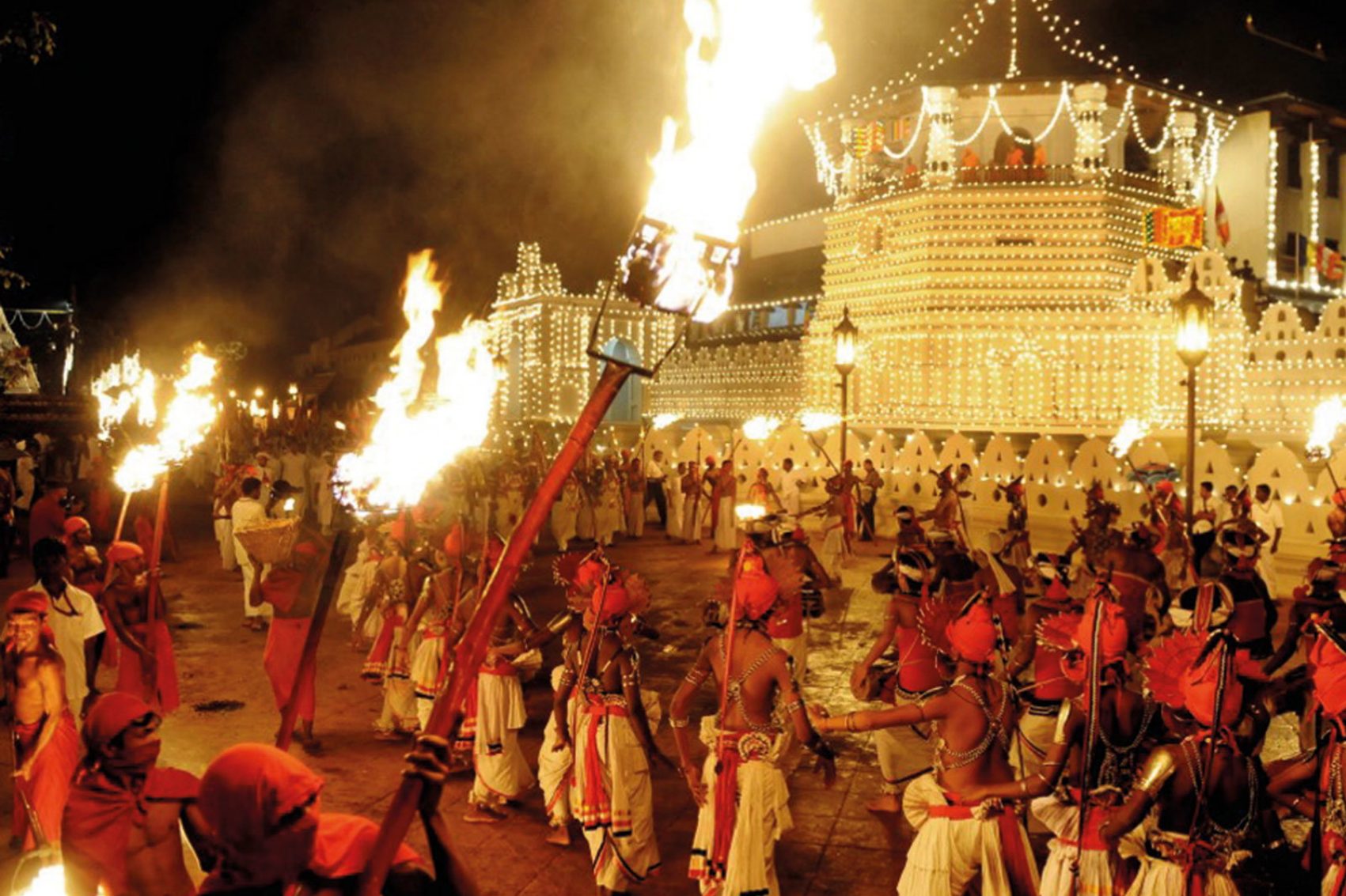 Men gathered around fire torches celebrating