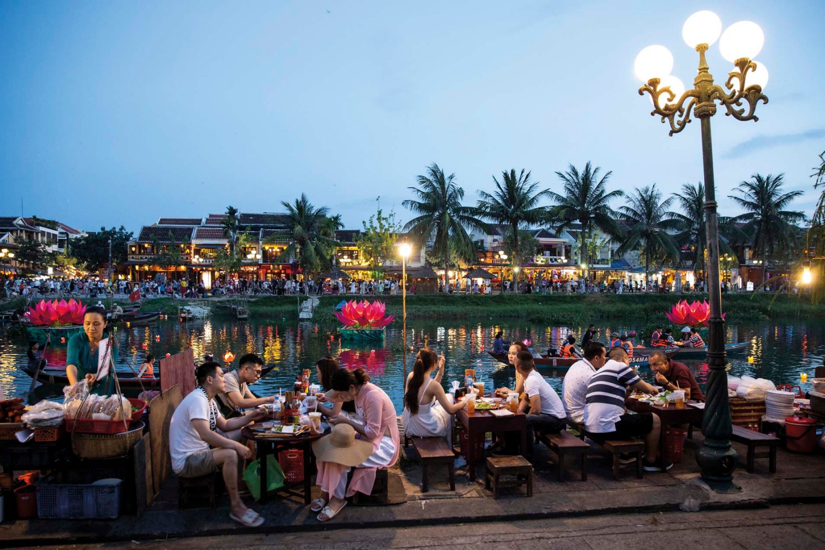 Crowds eating by the water in Hoi An. Credit: Cedric Arnold