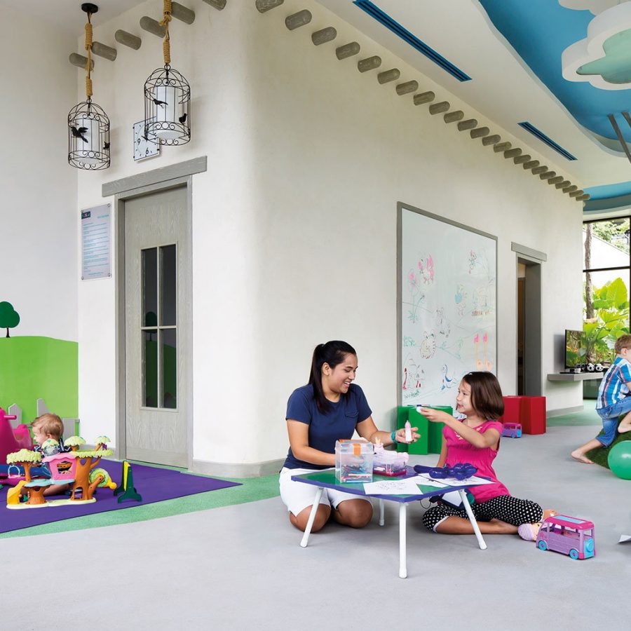 Family playing with toys in an indoor kids' playroom