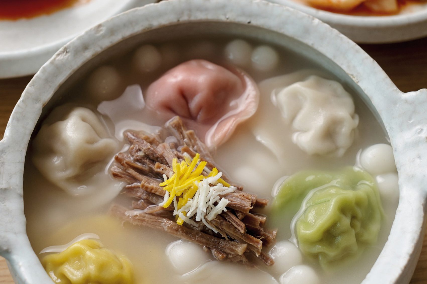 A bowl of naturally dyed dumplings in a light meat broth. Credit: Dylan Goldby  Jaha Mandu, Seoul, Korea
