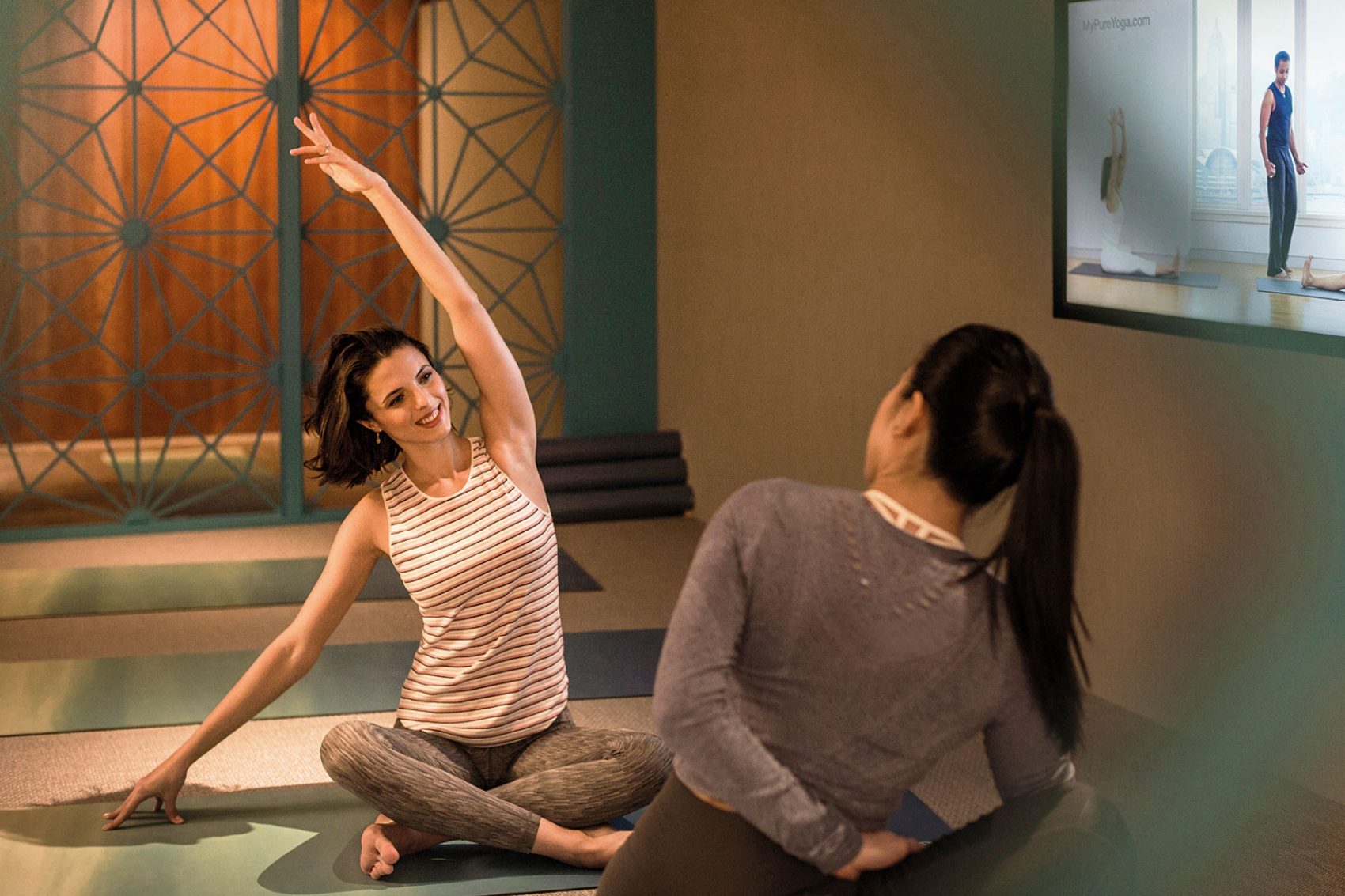 2 ladies practicing yoga 