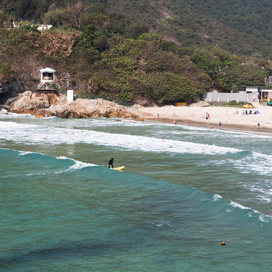 People surfing at Big Wave Bay beach in Hong Kong
