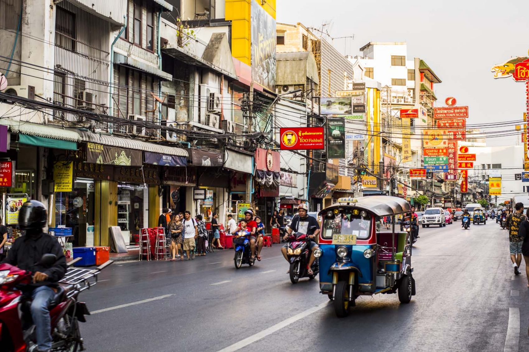A tuktuk drives down a street in Bangkok