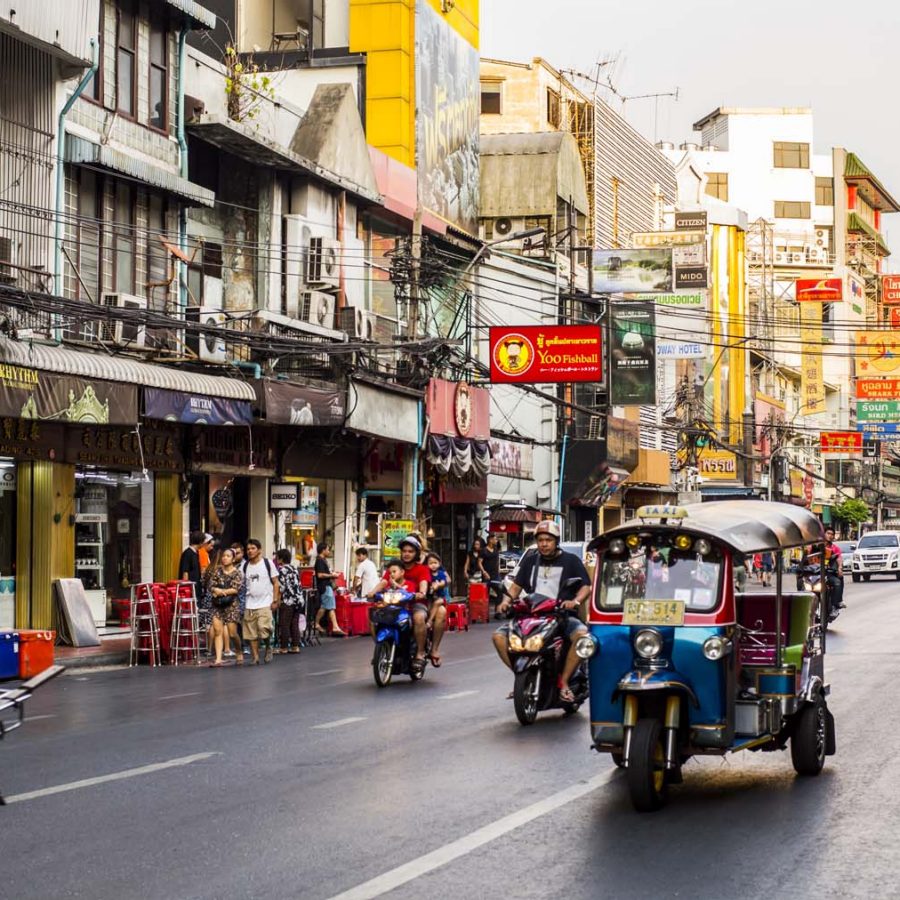 A tuktuk drives down a street in Bangkok