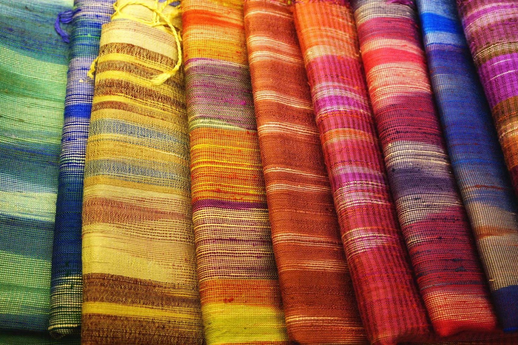 A row of rainbow silk bolts
