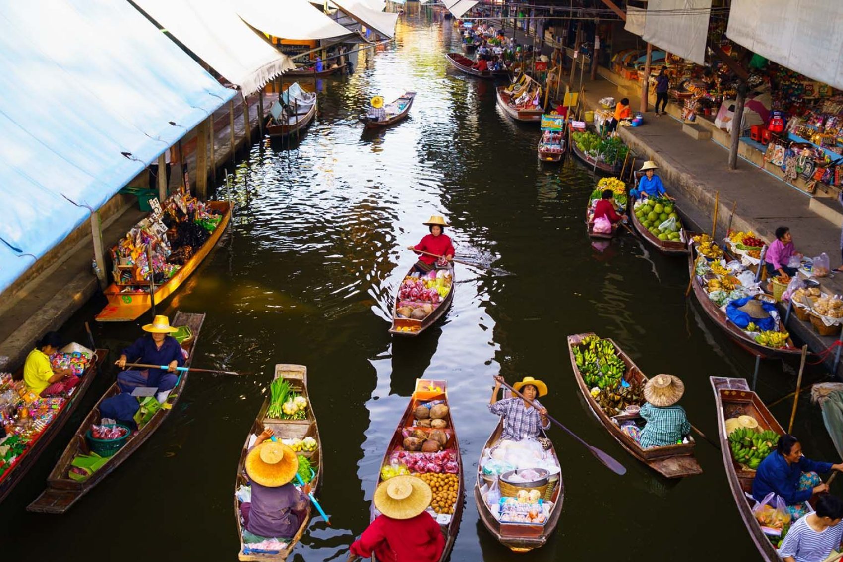 Boats sail down one of Bangkok's floating markets