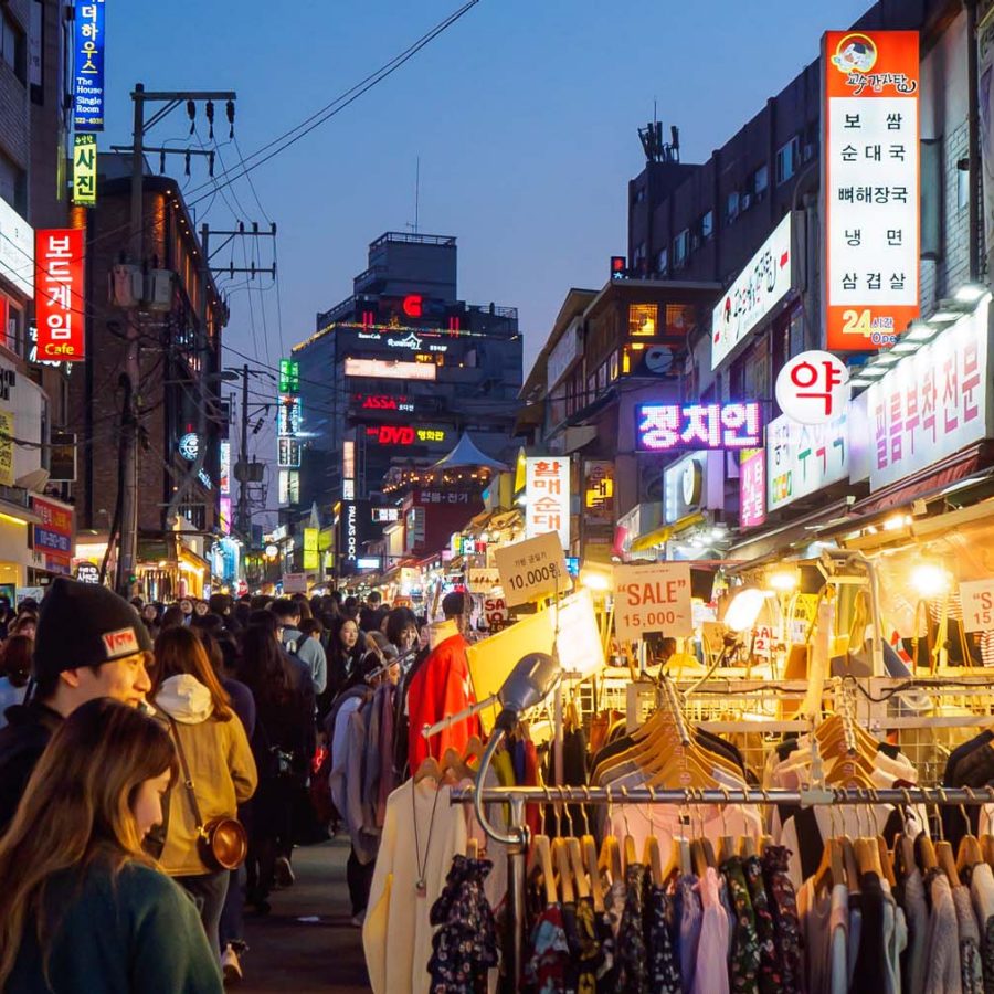 Crowds of people are shopping and walking in the Hongdae street market in Seoul, South Korea