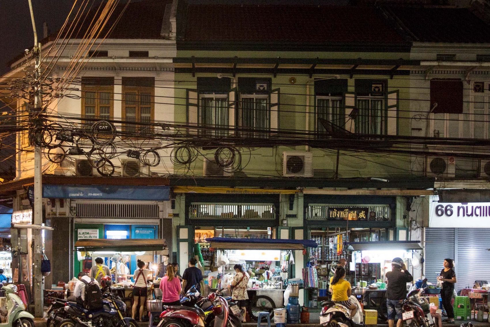 Bangkok street food night market customers grabbing a late night snack