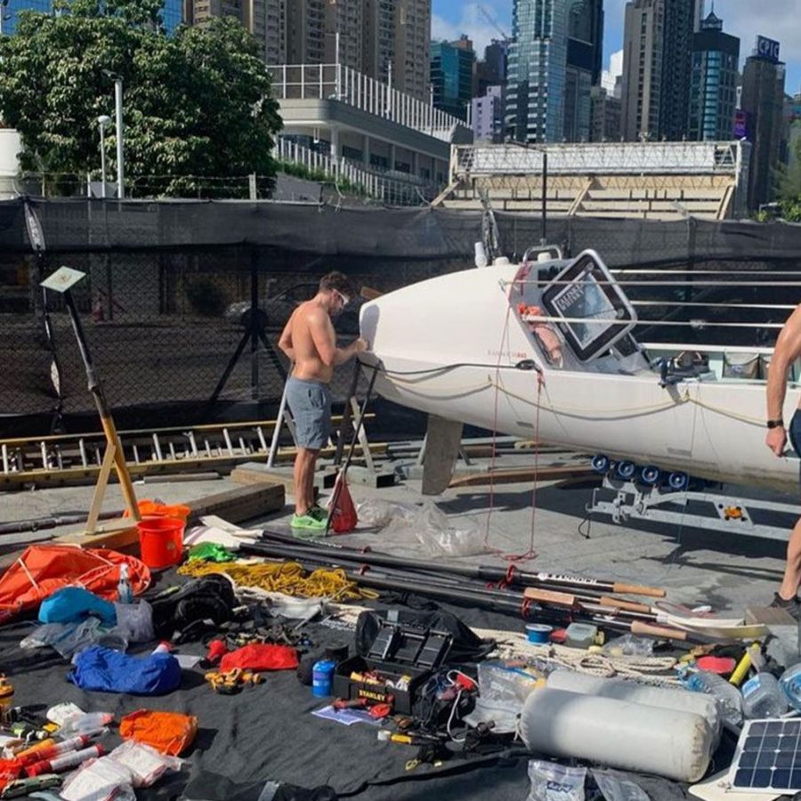 Rowers working on their boat in preparation to row across the Atlantic