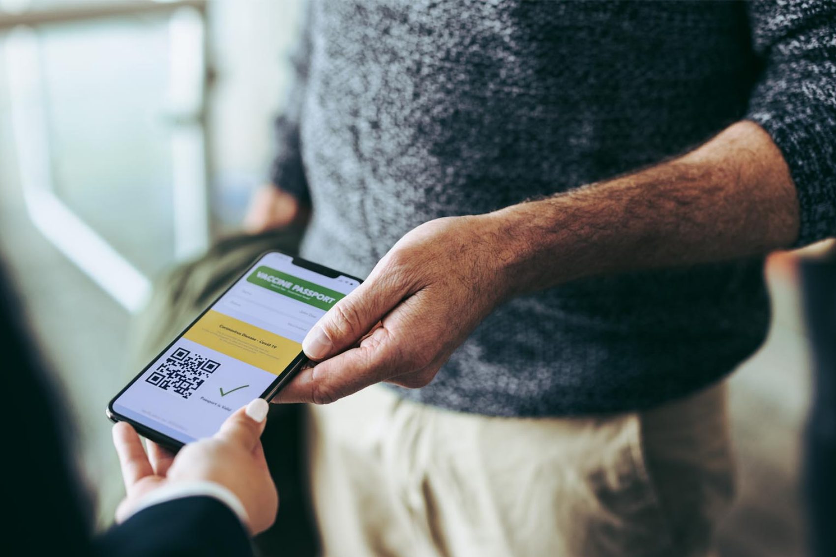 Man showing phone with Covid-19 related information on. Credit: iStock