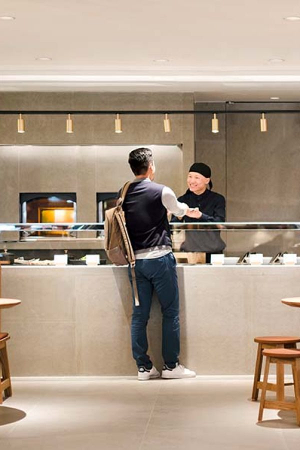 Lounge guest ordering food in the kitchen area