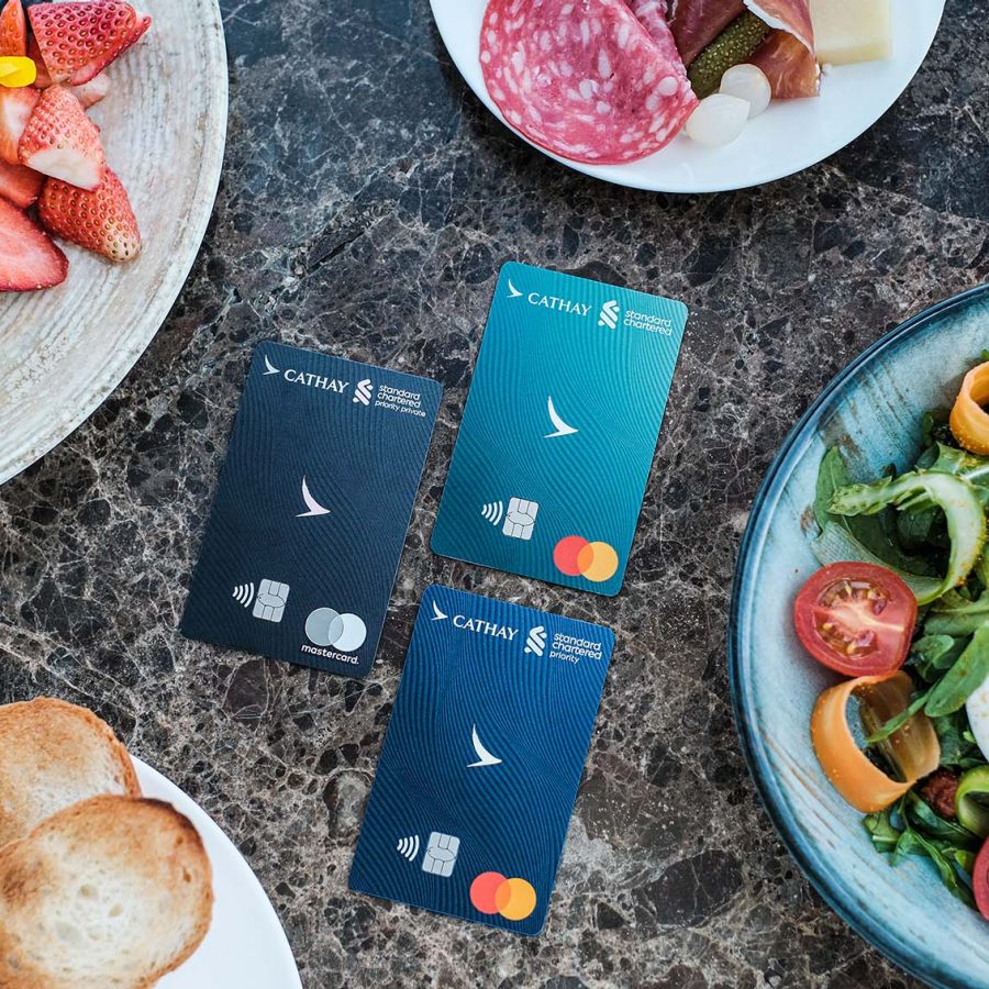 Cathay Pacific Standard Chartered credit cards surrounded by food