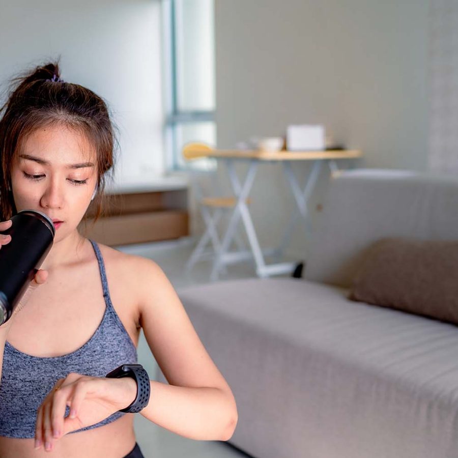 Woman checking watch wearing workout gear