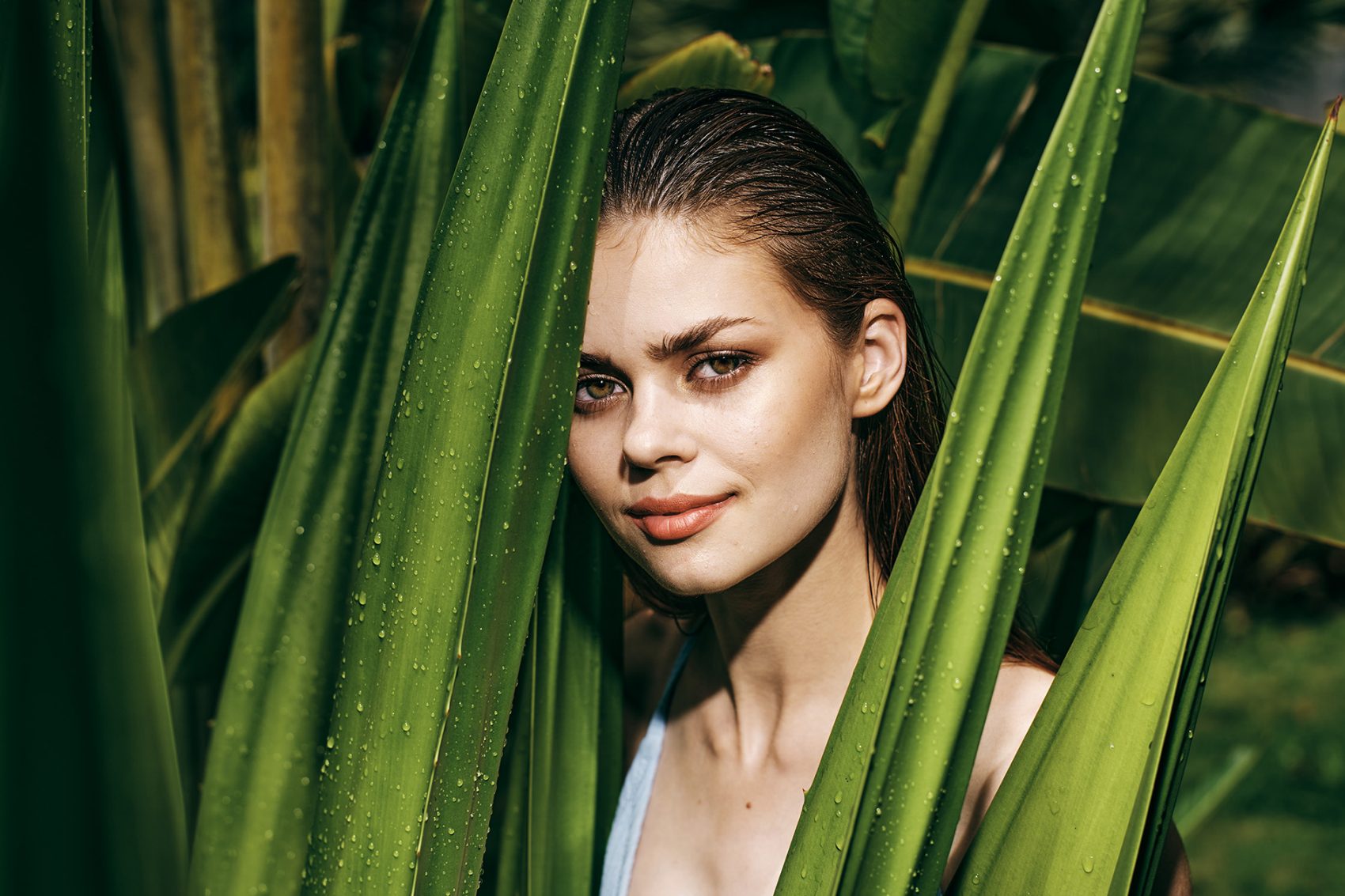 Woman behind aloe vera plant