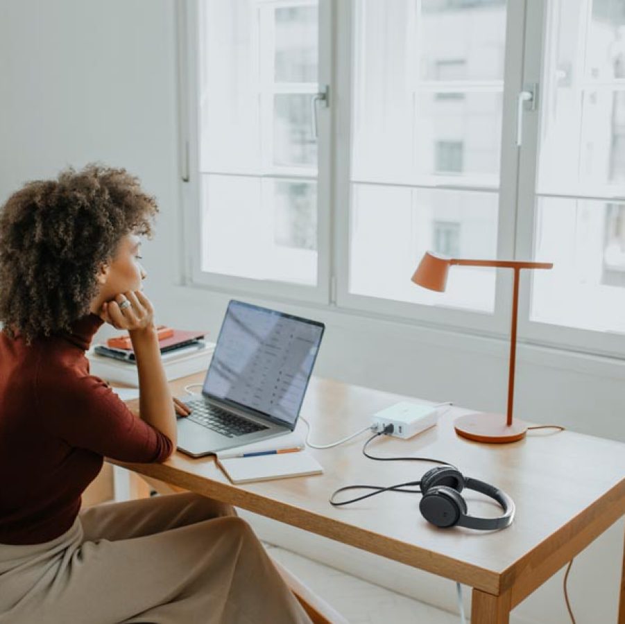 Woman at desk working using Belkin charger