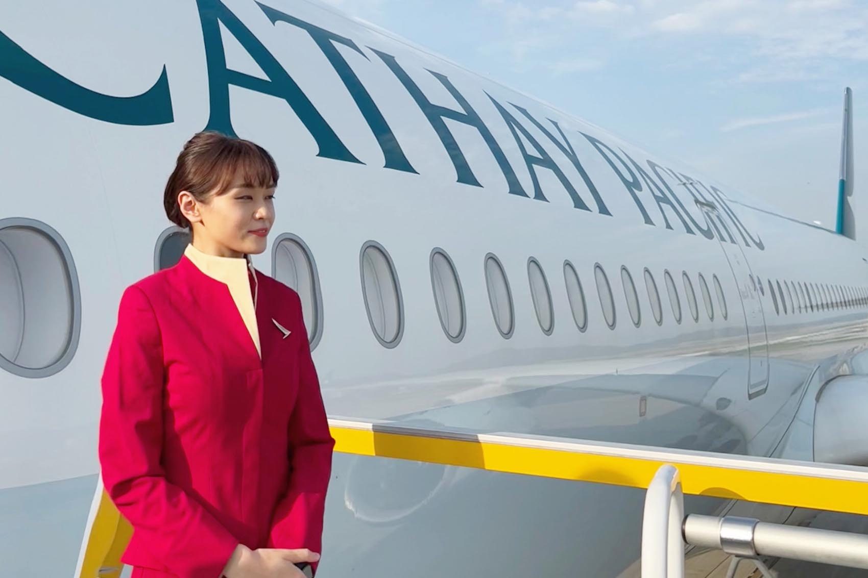Cabin crew standing by Cathay aircraft