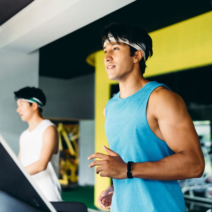 Men on running machines