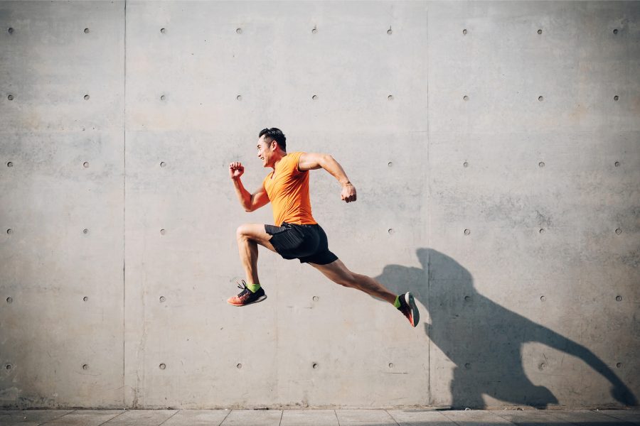 Man running in front of wall