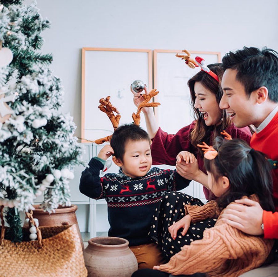 Family around Christmas tree. Credit: Getty Images