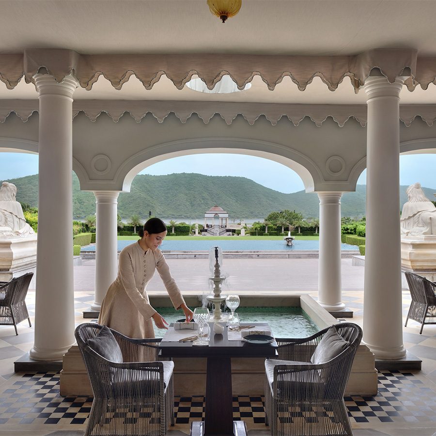 Waitress laying table in The Dining Room restaurant at Raffles Udaipur