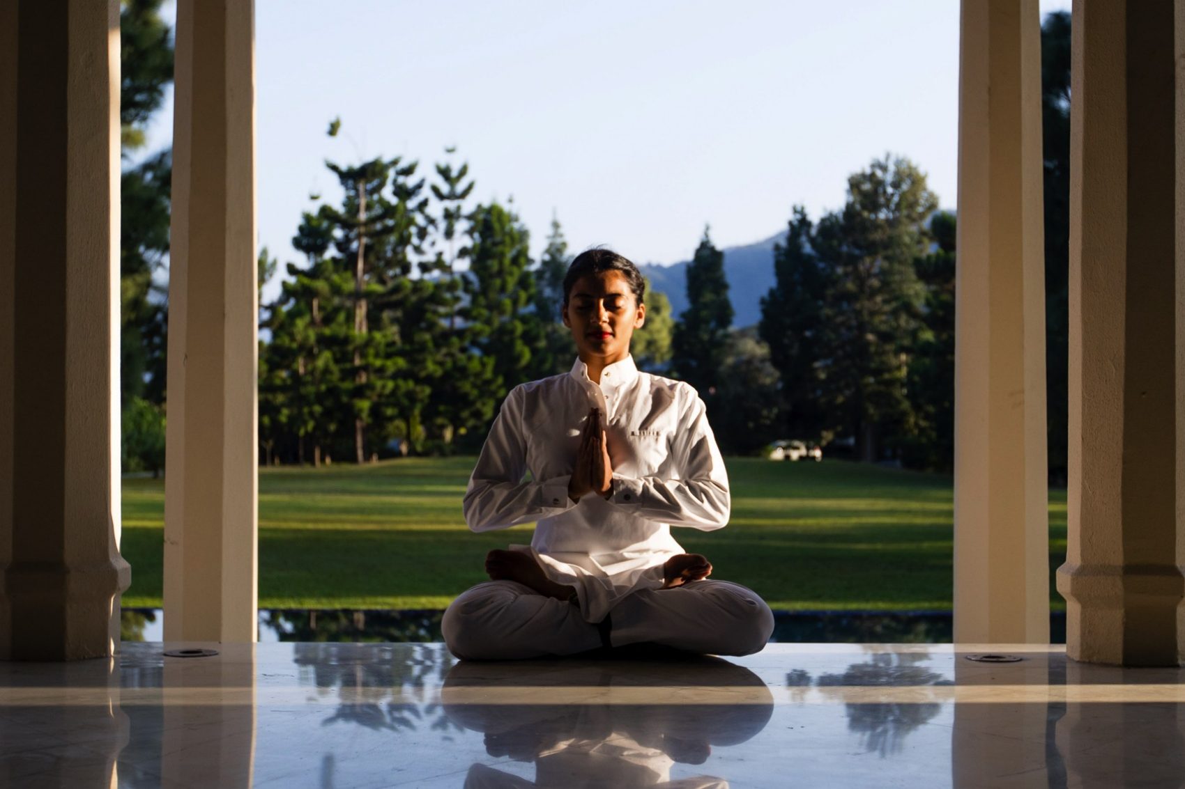 Person meditation by water