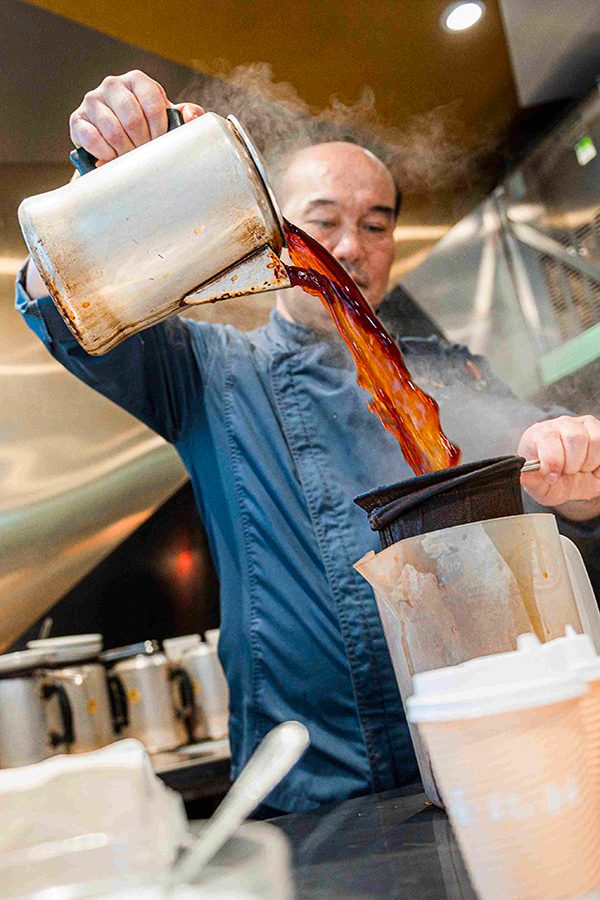 Man pouring milk tea