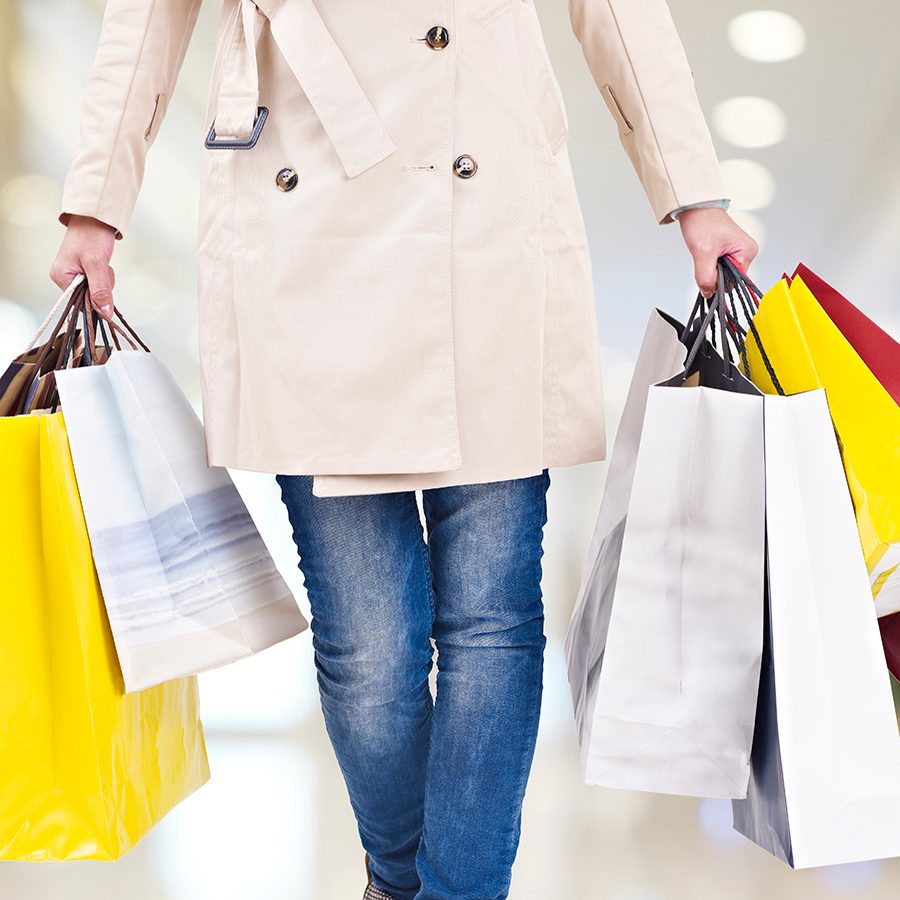 Person holding shopping bags. Credit: Getty Images