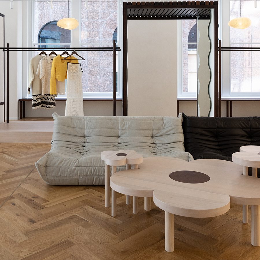 An interior view of Chinatown Country Club showroom decorated with a clothing rack, stylish mirror and luxurious furnitures in Sydney CBD, Australia