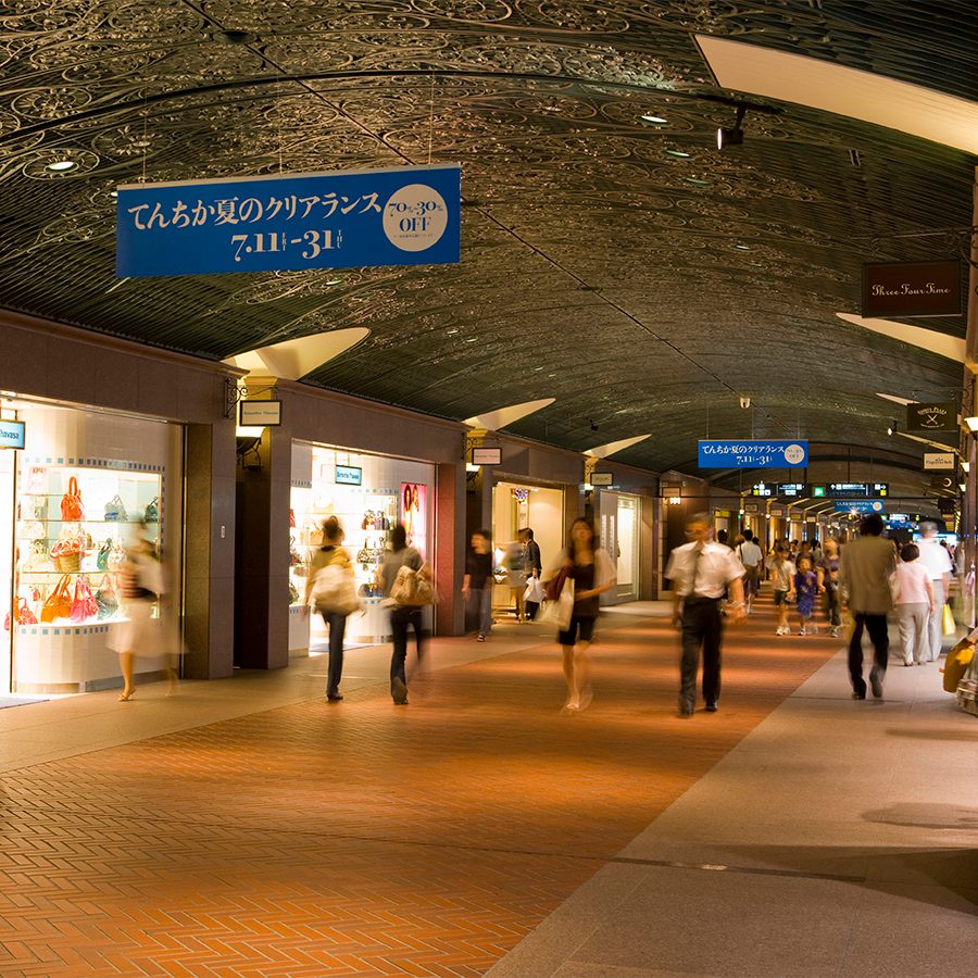 A crowd of people walking through Tenjin Chikagai underground mall 