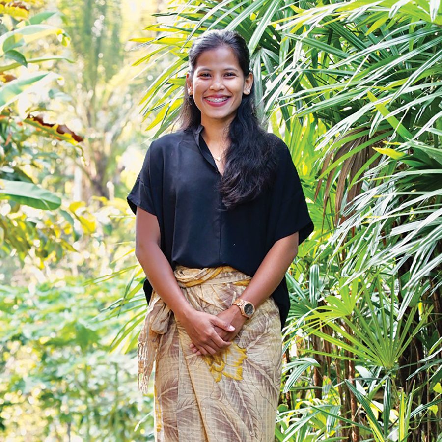 A woman standing amid plants