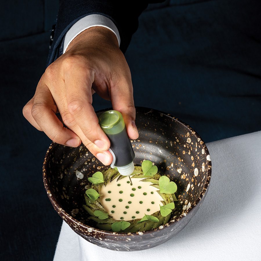 A bowl being plated