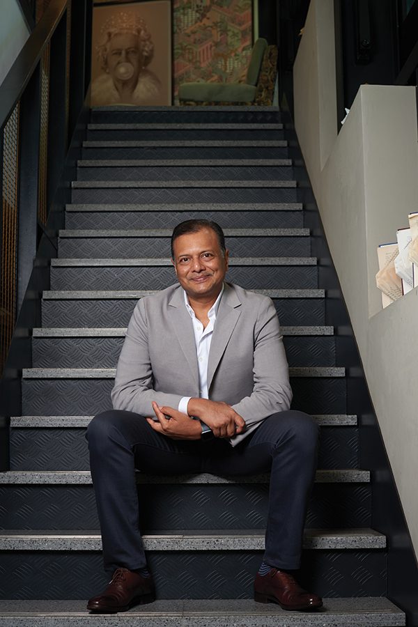 David Lees, Managing Director of Ariyasom Villa, sitting on stairs