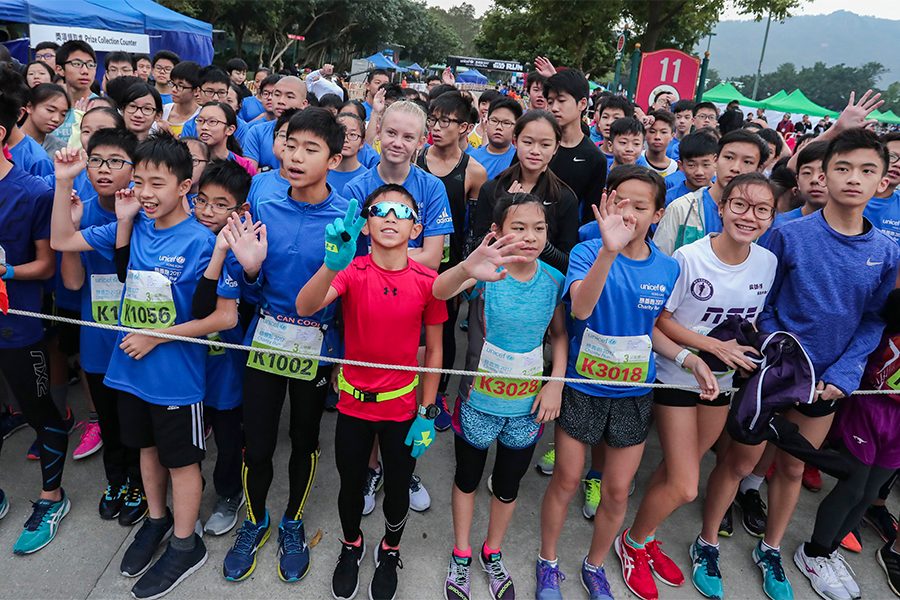 A group of young children pose together for a photo before the race begins at the Unicef 2023 Run for Every Child charity event