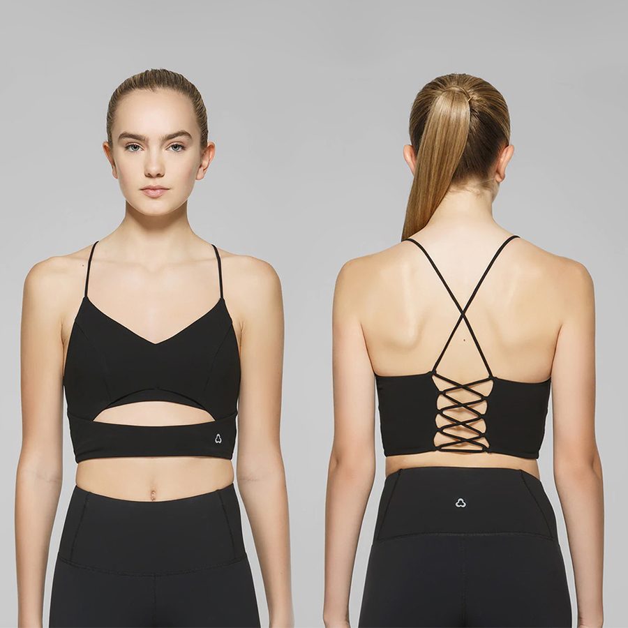 A woman wearing Titika Active Couture's black Luna Light Impact sports bra, front and back view