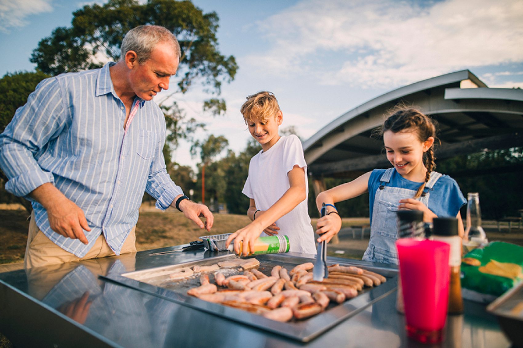 Parent and children enjoying barbeque