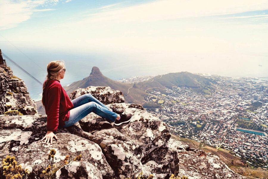 Woman sitting on mountain in Cape Town