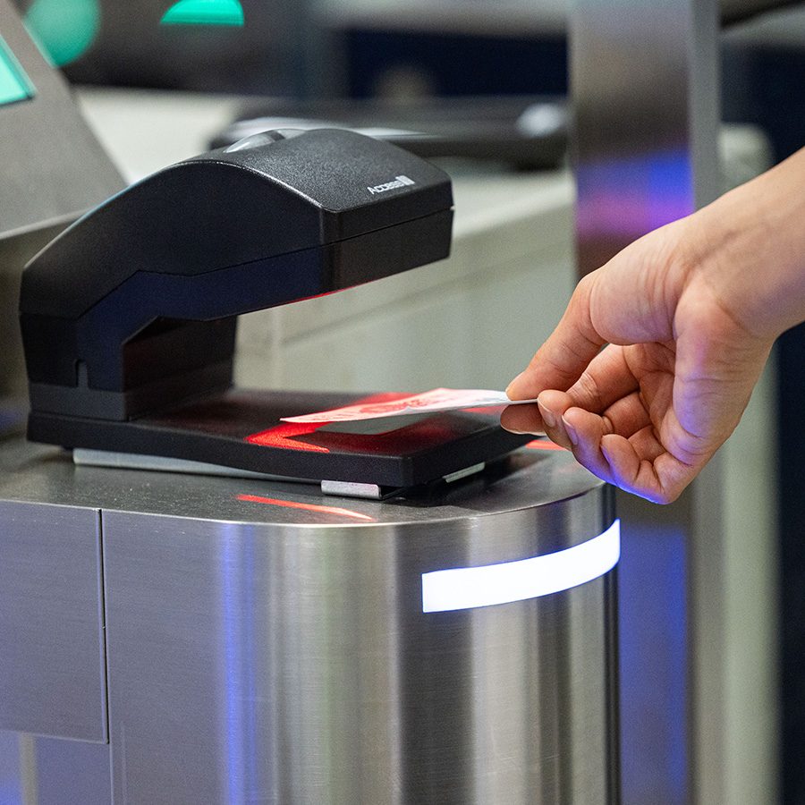 A close-up of a passenger scanning a transfer coach ticket at HKIA.