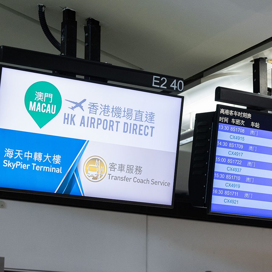 Monitors showing airport transfer schedules at HKIA.