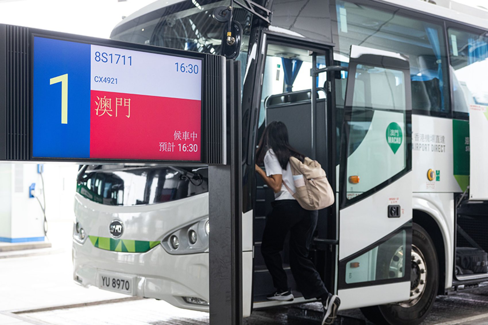 A passenger boards the transfer coach to Macao from HKIA. 