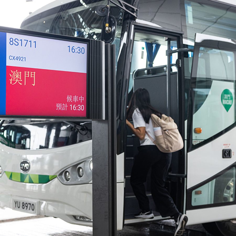 A passenger boards the transfer coach to Macao from HKIA. 