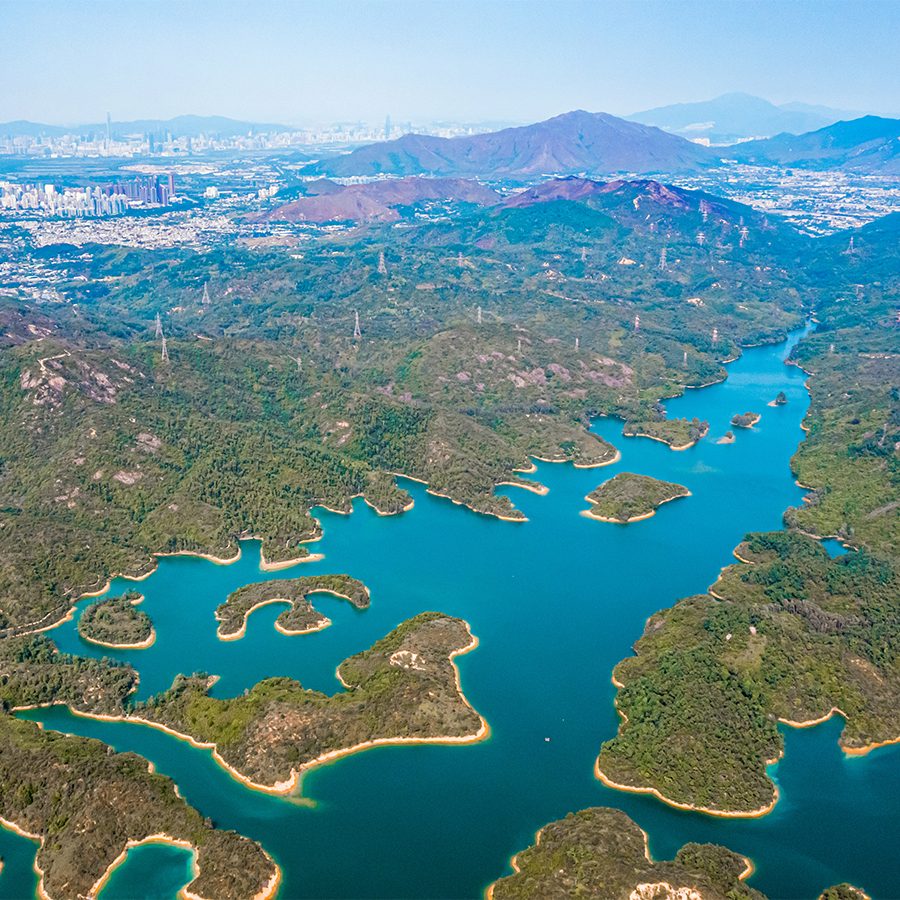 An aerial view of Tai Lam Country Park surrounded by trees and water in New Territories, Hong Kong