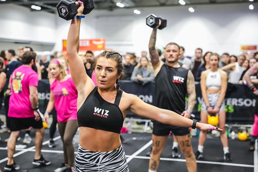 A group of men and women lifting dumbells at Turg Games 