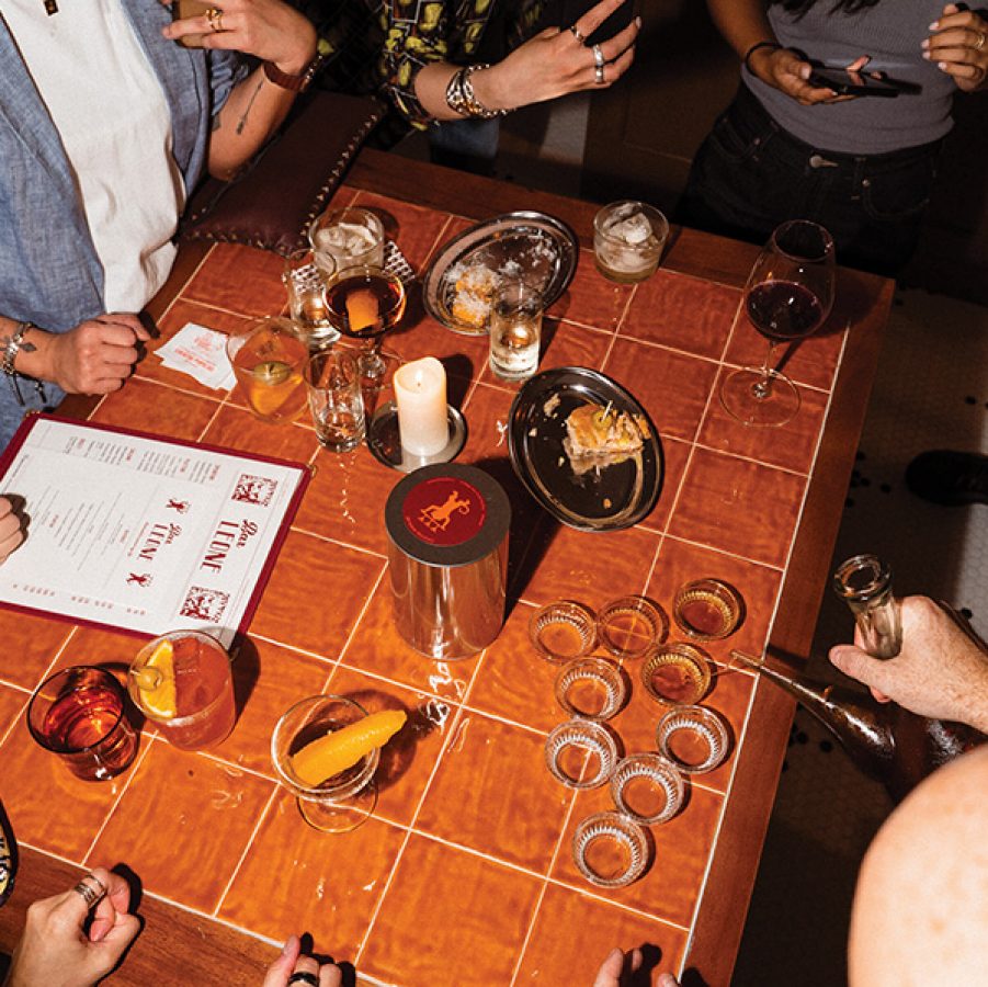 People gathered around table in Bar Leone Hong Kong.