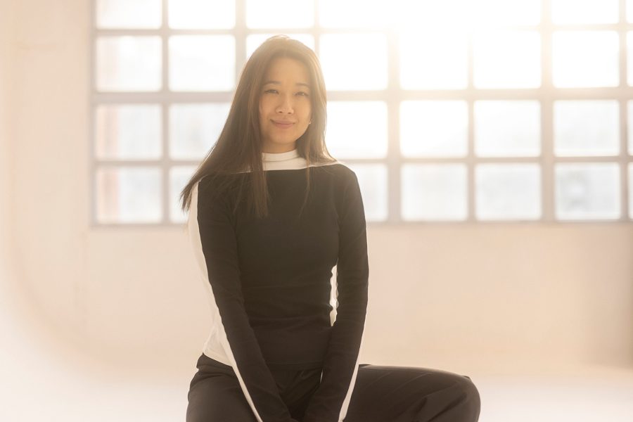 Artist Carla Chan sitting in a studio