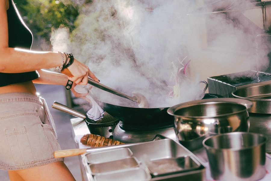 Sam Lui of Wendy's Wok cooking food in a wok
